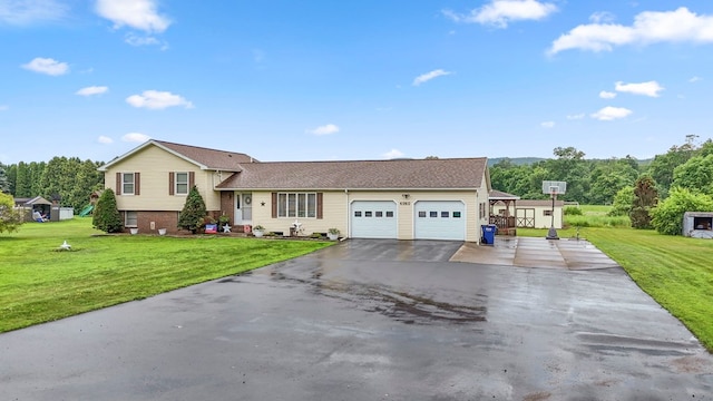 4060 Wilawana Rd, Sayre, PA 18840 - tri-level home featuring a garage, asphalt driveway, and a front yard