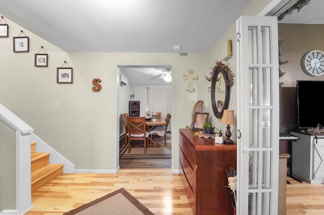 4060 Wilawana Rd, Sayre, PA 18840 - foyer entrance with light wood-style flooring, a ceiling fan, a wall unit AC, and stairway