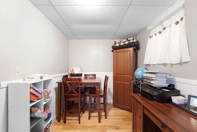 4060 Wilawana Rd, Sayre, PA 18840 - dining space featuring a paneled ceiling, wainscoting, light wood-style floors, and a decorative wall