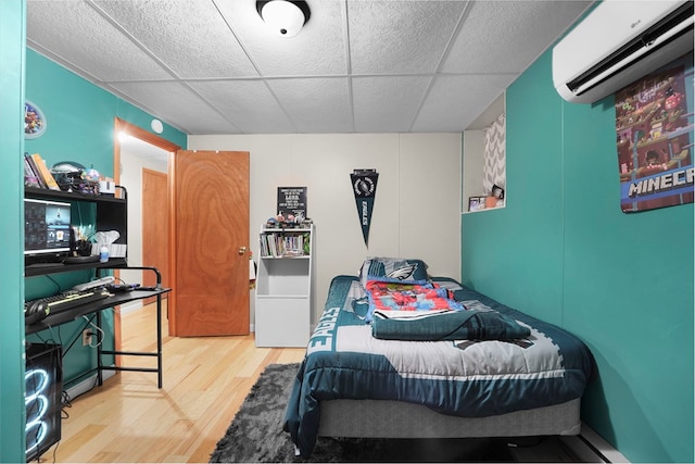4060 Wilawana Rd, Sayre, PA 18840 - bedroom with a wall mounted AC, wood finished floors, and a paneled ceiling