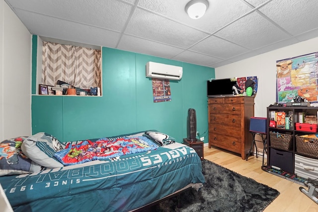 4060 Wilawana Rd, Sayre, PA 18840 - bedroom featuring an AC wall unit, wood finished floors, and a drop ceiling
