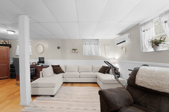 4060 Wilawana Rd, Sayre, PA 18840 - living area with a wall mounted AC, wood finished floors, a drop ceiling, and a wainscoted wall