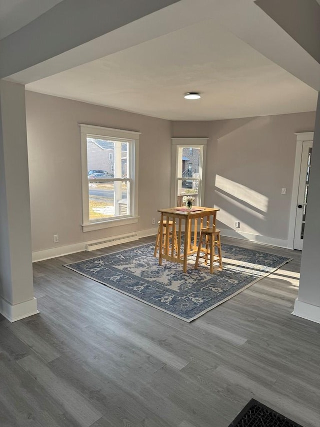 dining area with dark wood finished floors and baseboards