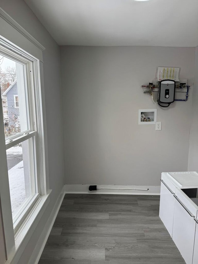 washroom with cabinet space, baseboards, and wood finished floors