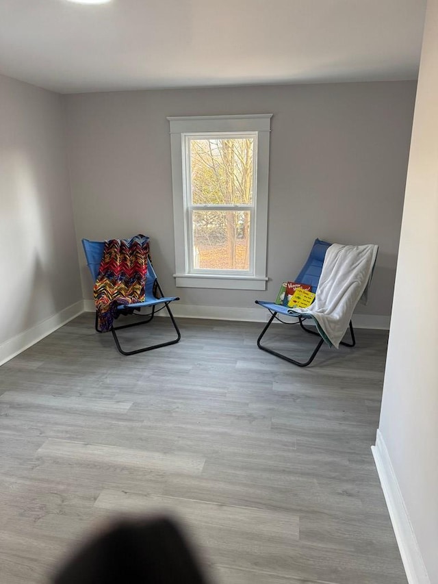 sitting room featuring baseboards and wood finished floors