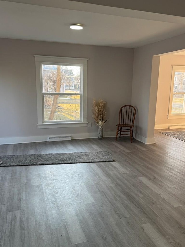 unfurnished room with visible vents, baseboards, and wood finished floors