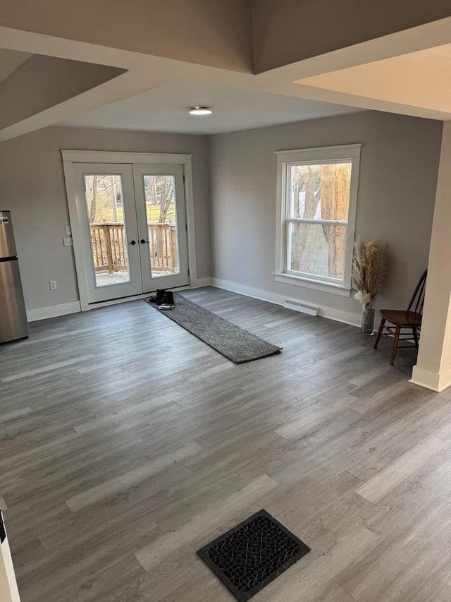 entryway with visible vents, baseboards, wood finished floors, and french doors