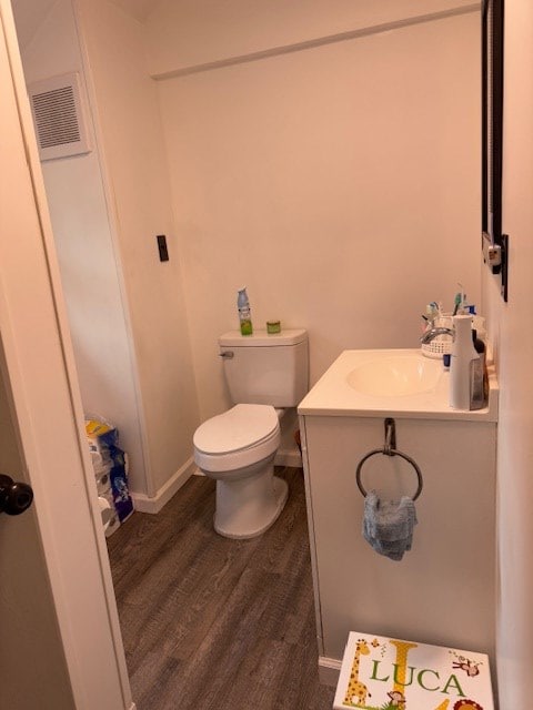 bathroom featuring vanity, toilet, and wood-type flooring