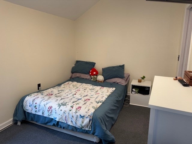 carpeted bedroom with vaulted ceiling