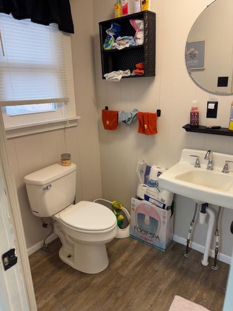 bathroom with wood-type flooring and toilet