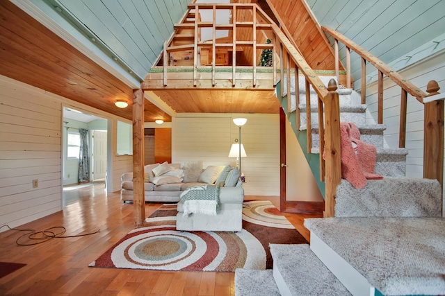 157 Shelmire Rd, Wellsboro, PA 16901 - living room with lofted ceiling, stairs, wooden walls, and wood-type flooring