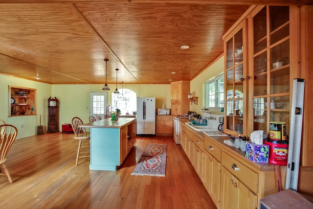 157 Shelmire Rd, Wellsboro, PA 16901 - kitchen featuring freestanding refrigerator, a kitchen breakfast bar, light wood finished floors, stove, and wood ceiling