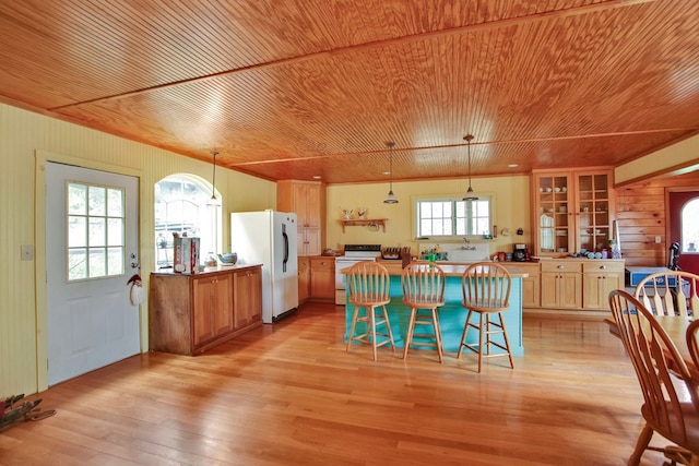 157 Shelmire Rd, Wellsboro, PA 16901 - kitchen with wood ceiling, light wood-style flooring, freestanding refrigerator, a kitchen breakfast bar, and electric stove
