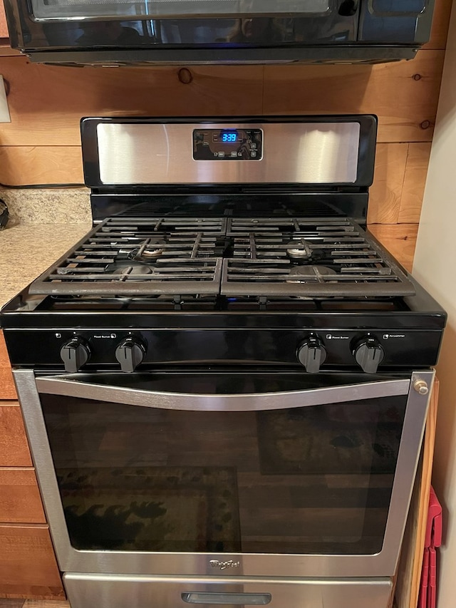 interior details with gas stove and light countertops