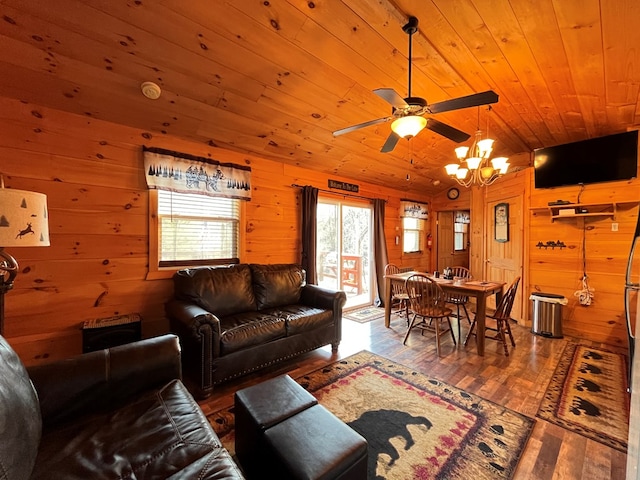 living room featuring hardwood / wood-style flooring, wooden walls, lofted ceiling, wood ceiling, and ceiling fan