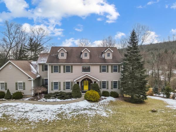 colonial home with a lawn