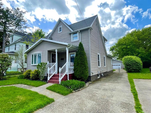 114 Elsbree St, Sayre, PA 18840 - view of front of property with an outbuilding, a porch, a detached garage, and a front yard