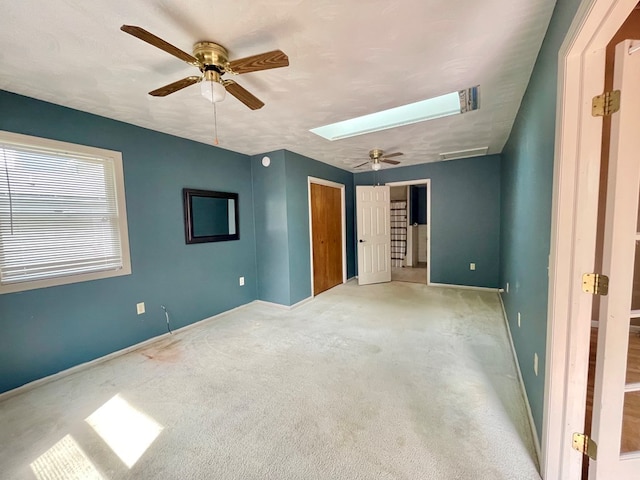 114 Elsbree St, Sayre, PA 18840 - unfurnished bedroom with baseboards, a skylight, carpet floors, and ceiling fan