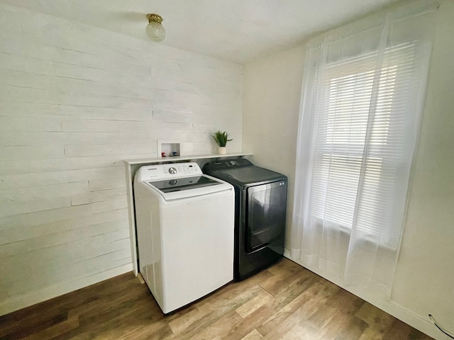 114 Elsbree St, Sayre, PA 18840 - clothes washing area with separate washer and dryer, light wood finished floors, and plenty of natural light