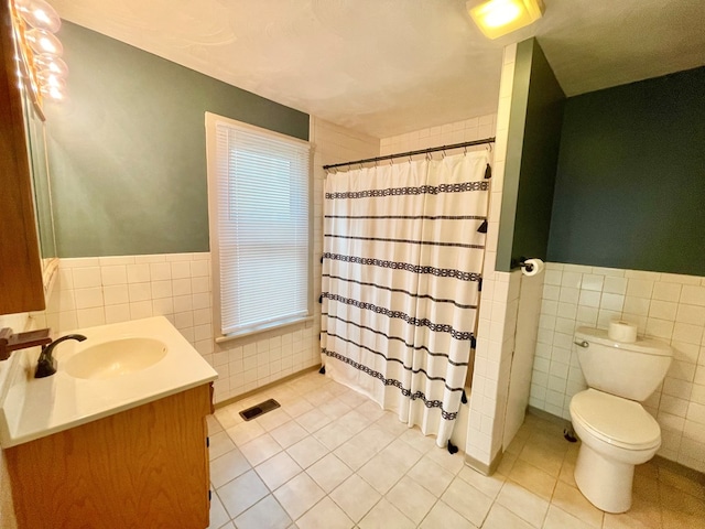 114 Elsbree St, Sayre, PA 18840 - full bath with tile walls, tile patterned floors, toilet, wainscoting, and vanity