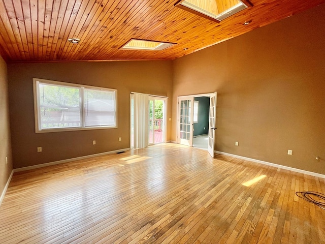 114 Elsbree St, Sayre, PA 18840 - spare room with healthy amount of natural light, a skylight, light wood finished floors, vaulted ceiling, and wooden ceiling