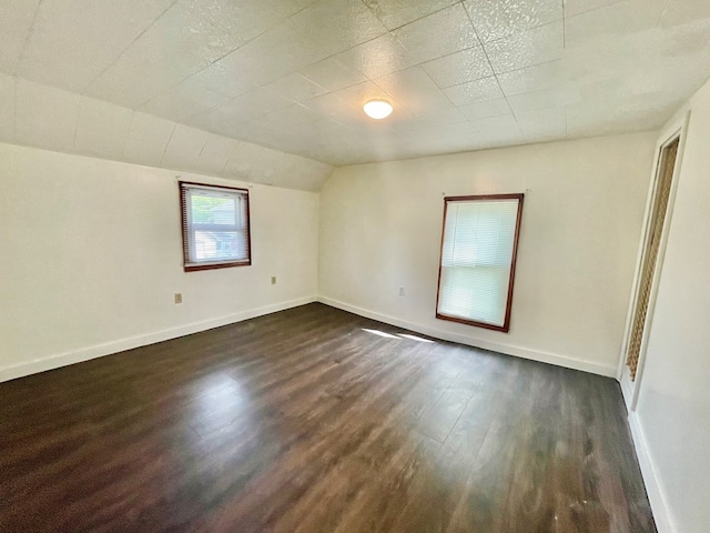 114 Elsbree St, Sayre, PA 18840 - spare room with dark wood finished floors, baseboards, and vaulted ceiling