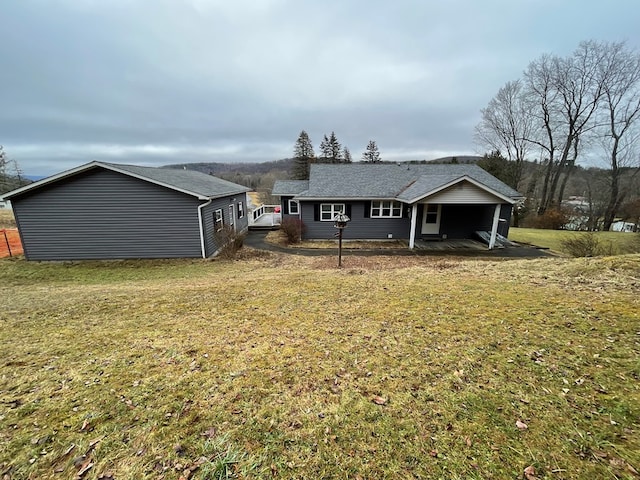 back of property featuring a lawn