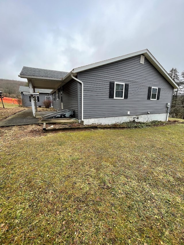 rear view of house featuring a patio and a lawn