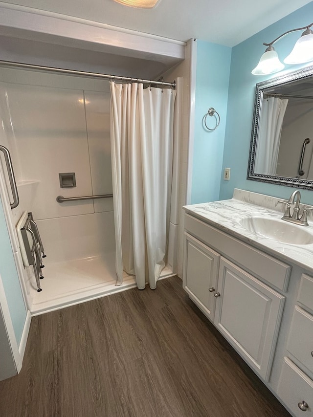 bathroom featuring hardwood / wood-style flooring, vanity, and a shower with shower curtain