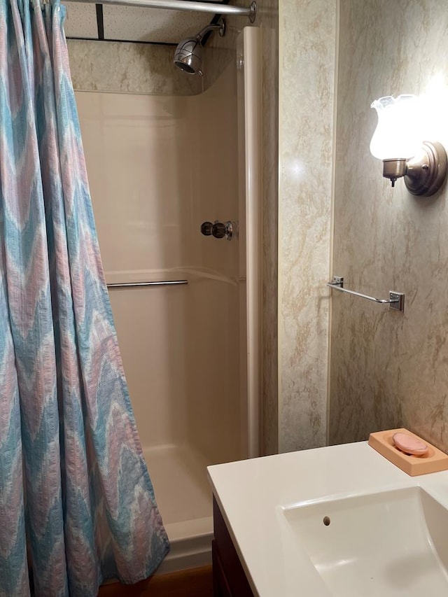 bathroom with sink and a shower with shower curtain