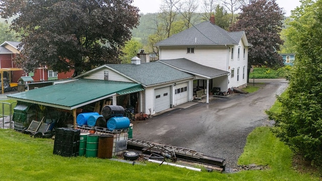 2779 Stony Fork Rd, Wellsboro, PA 16901 - view of front of property featuring an attached garage, a chimney, roof with shingles, driveway, and a front yard
