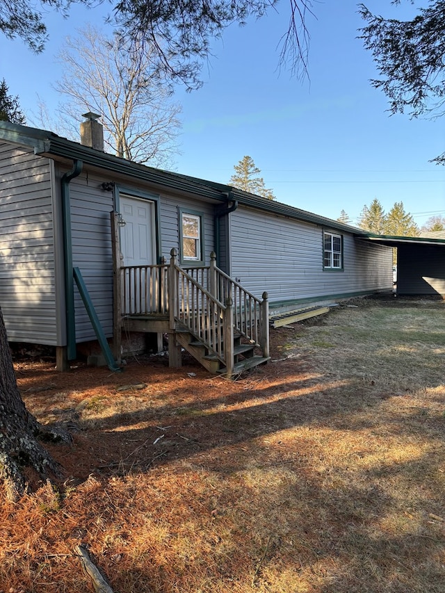 rear view of house featuring a chimney