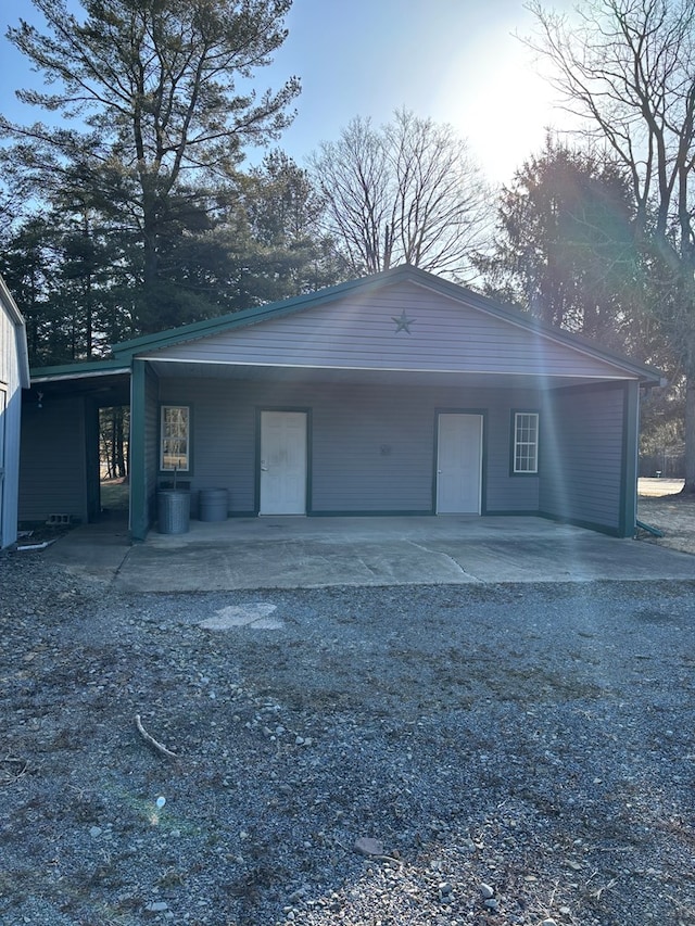 garage with a carport, central AC, and driveway