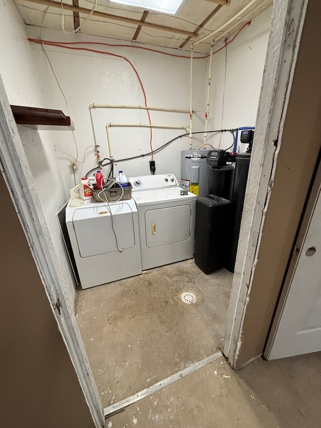 washroom with laundry area, electric water heater, and separate washer and dryer