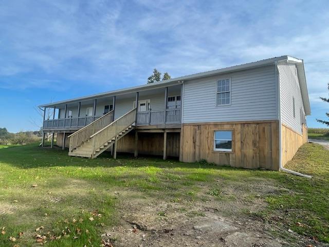 rear view of property with a yard