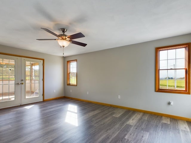 empty room with ceiling fan, dark wood-type flooring, and french doors