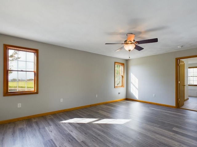 empty room with hardwood / wood-style floors and ceiling fan