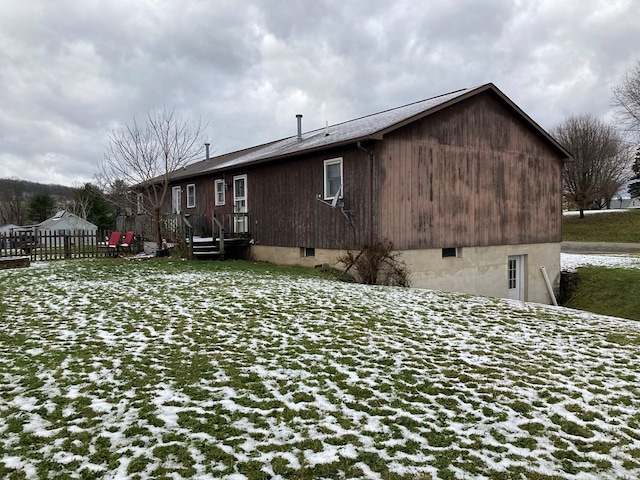 view of snow covered back of property