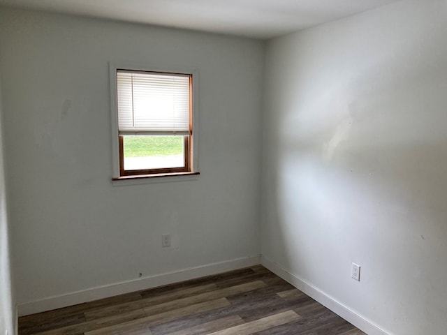 spare room with dark hardwood / wood-style floors