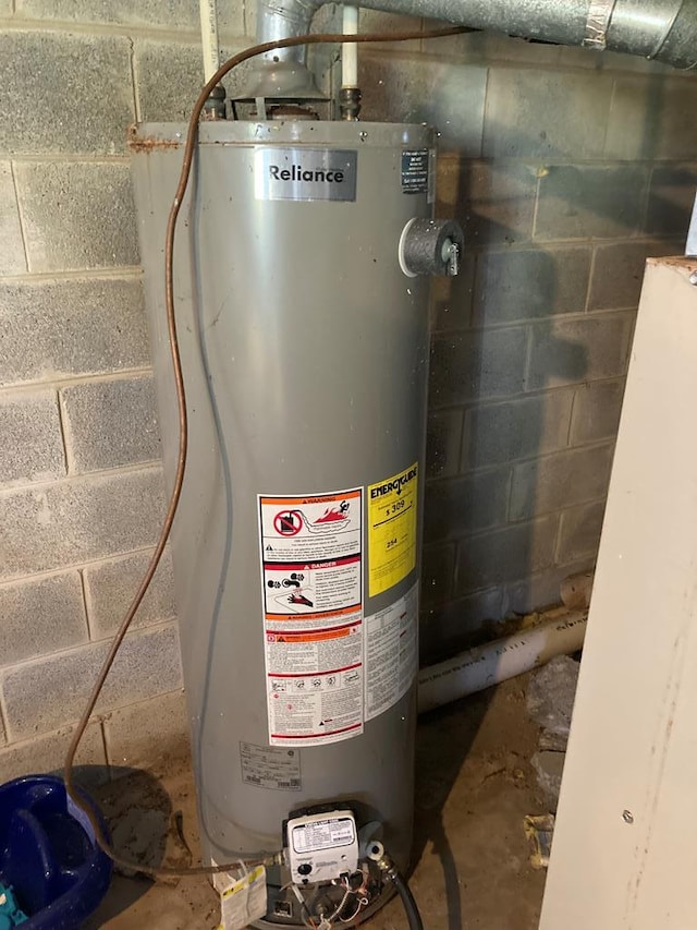 utility room featuring gas water heater