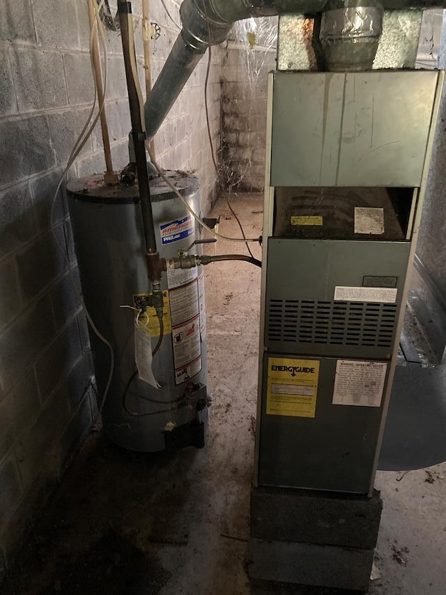 utility room featuring heating unit and gas water heater