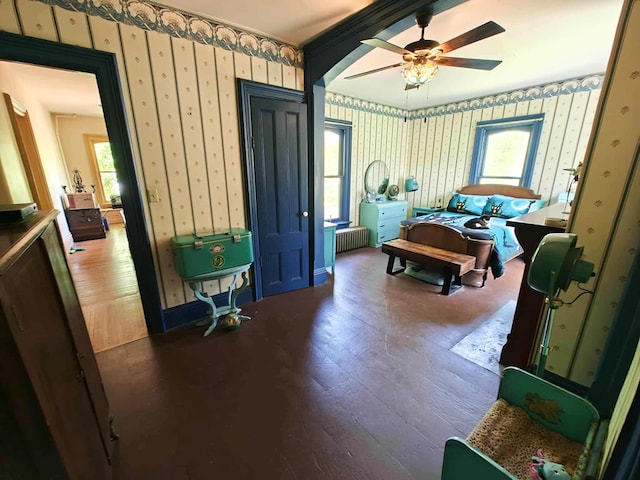440 Park Ave, Waverly, NY 14892 - bedroom with wallpapered walls, wood-type flooring, radiator, and a ceiling fan