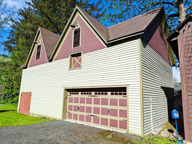 440 Park Ave, Waverly, NY 14892 - view of side of property featuring a shingled roof, asphalt driveway, and an attached garage