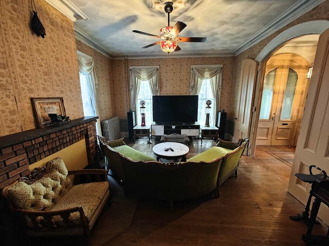 440 Park Ave, Waverly, NY 14892 - living room featuring wallpapered walls, wood finished floors, a ceiling fan, plenty of natural light, and radiator heating unit
