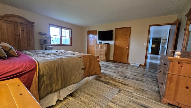 8065 Rte 414, Liberty, PA 16930 - bedroom featuring wood finished floors, baseboards, and visible vents