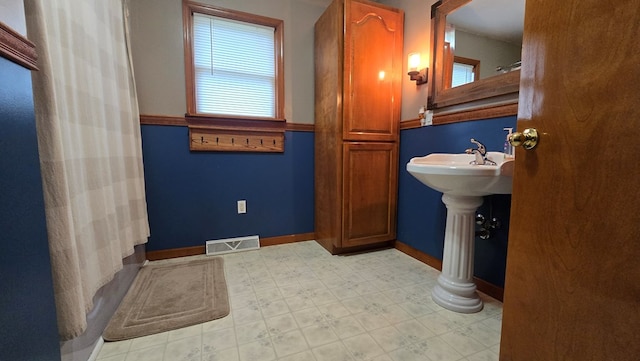 8065 Rte 414, Liberty, PA 16930 - bathroom with visible vents, baseboards, a sink, decorative columns, and tile patterned floors
