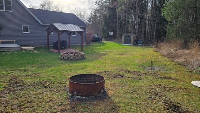 8065 Rte 414, Liberty, PA 16930 - view of yard with an outdoor structure, a wooden deck, an outdoor fire pit, a gazebo, and a storage unit