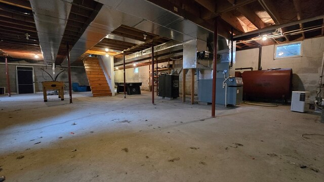 8065 Rte 414, Liberty, PA 16930 - basement with stairway, heating unit, and heating fuel