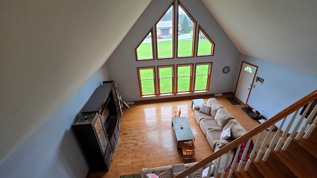 8065 Rte 414, Liberty, PA 16930 - living room featuring high vaulted ceiling, light wood-type flooring, and baseboards