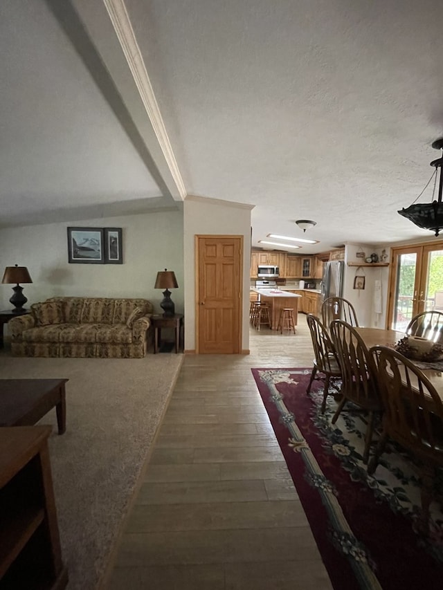 living room with french doors, hardwood / wood-style flooring, and crown molding